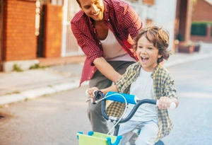 Father teaching son to ride a bike